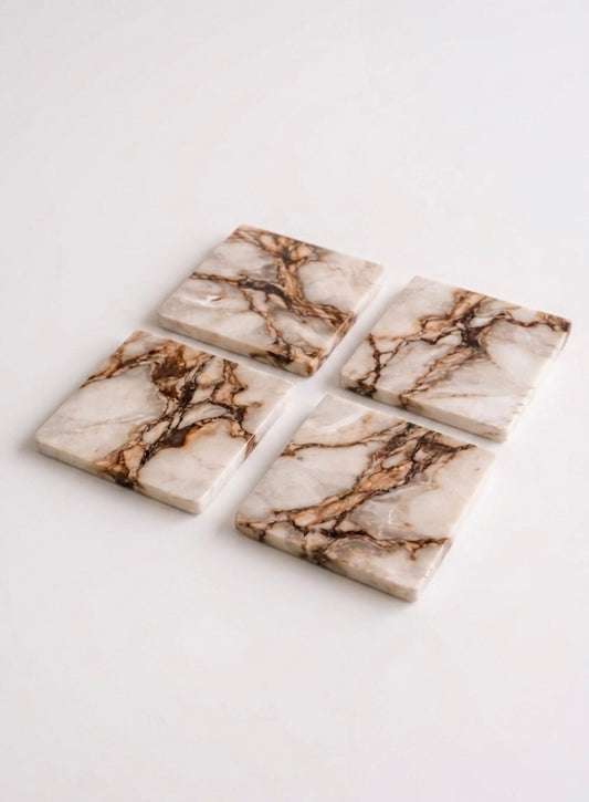 Vyasaara - Four marble-patterned coasters on a white background