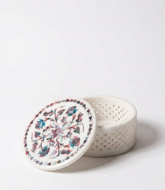 Vyasaara - White ceramic container with floral lid on a white background