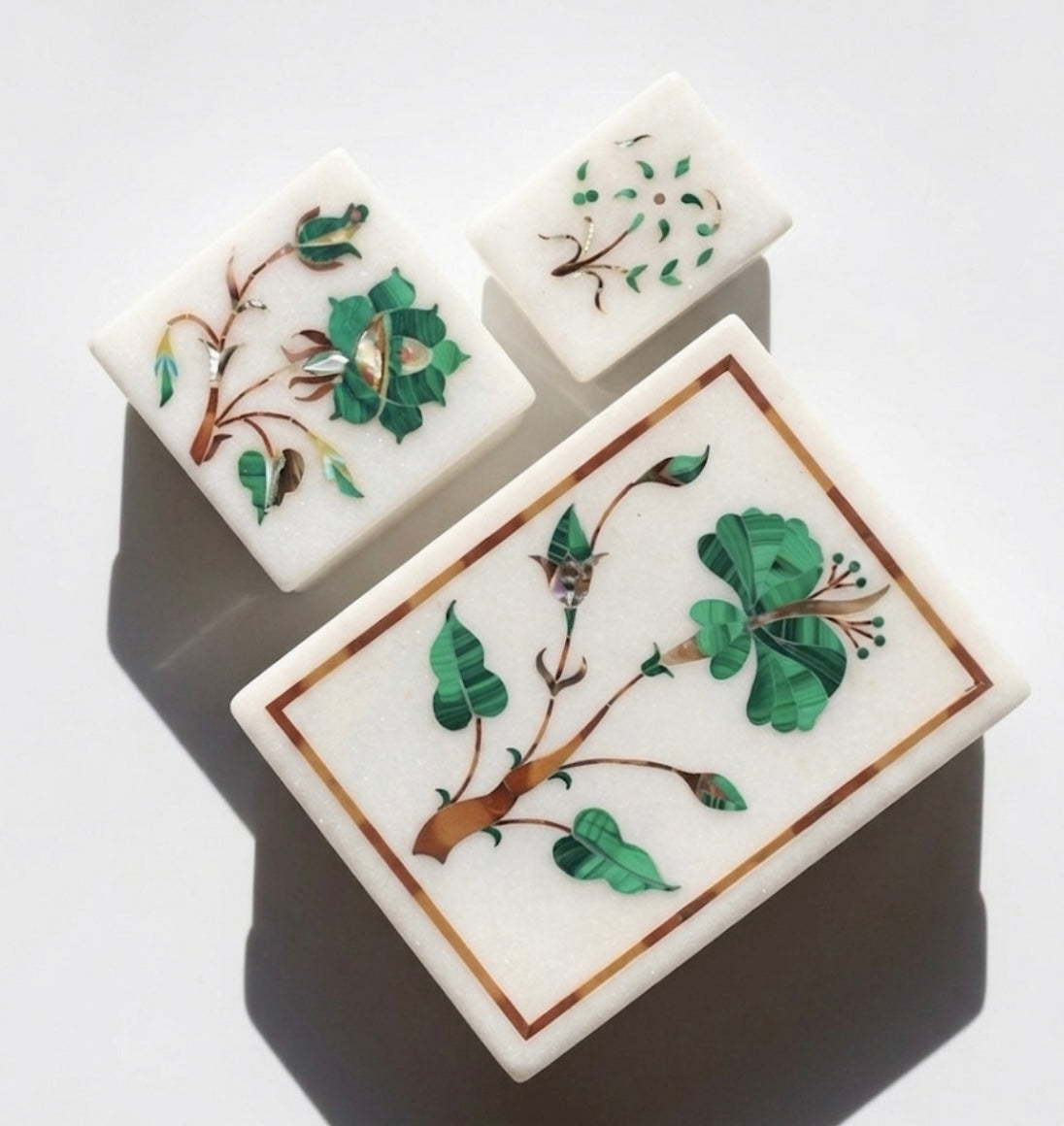 Vyasaara - Decorative stone tiles with floral patterns on a white background