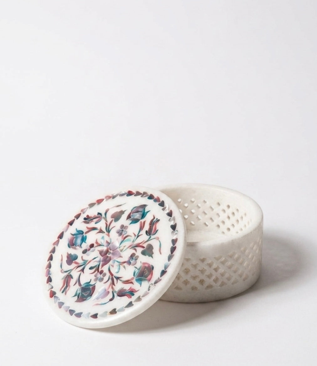 Vyasaara  - White ceramic container with floral lid on a white background